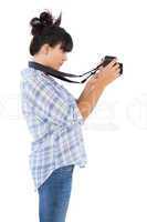 Concentrated young woman taking picture with her camera