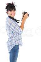 Smiling young woman taking picture with her camera