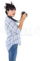 Surprised young woman taking picture with her camera