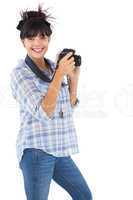 Happy young woman taking picture with her camera