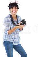 Cheerful young woman taking picture with her camera