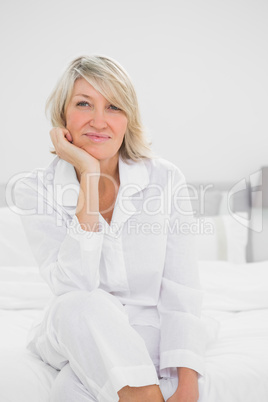 Cheerful  woman sitting in her bedroom