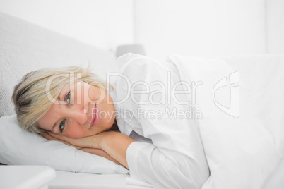 Relaxed woman lying in her bed