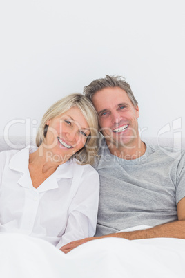 Smiling couple in bed