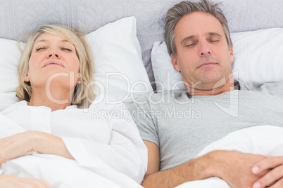 Couple sleeping in their bed