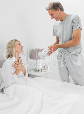 Man giving present to his surprised partner