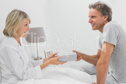 Man giving present to his smiling partner