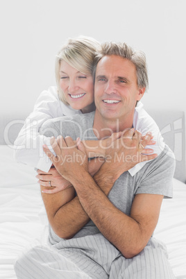 Embracing couple smiling at camera