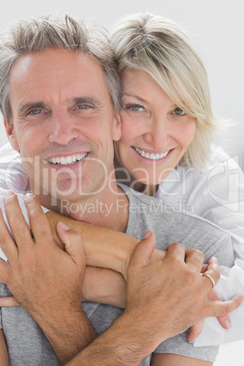 Hugging couple smiling at camera