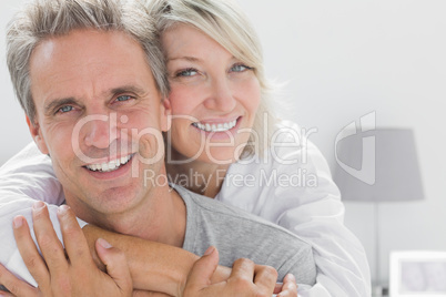 Affectionate couple smiling at camera