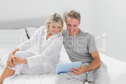 Happy couple using their digital tablet