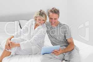 Happy couple using their digital tablet