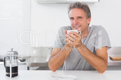 Man having coffee in kitchen