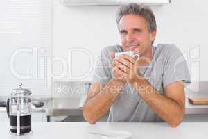 Man having coffee in kitchen