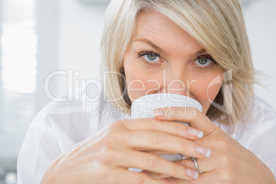 Happy woman drinking coffee in the morning