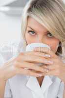Happy woman sipping coffee in the morning