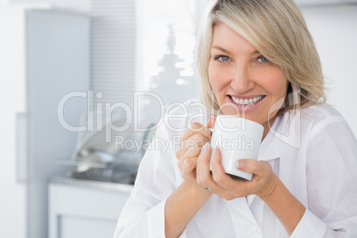 Happy woman having coffee in the morning