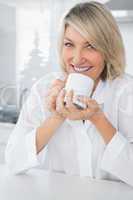 Cheerful woman having coffee in the morning