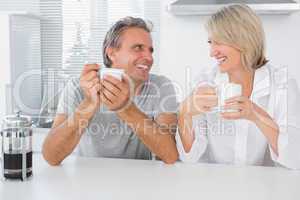 Cheerful couple having coffee in the morning