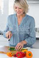 Smiling woman preparing vegetables