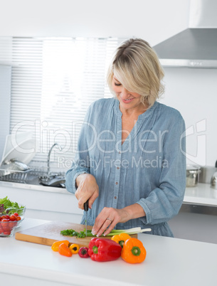 Cheerful woman preparing vegetables