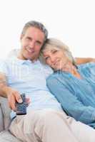 Cheerful couple on their couch watching tv