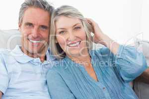 Smiling couple on their couch