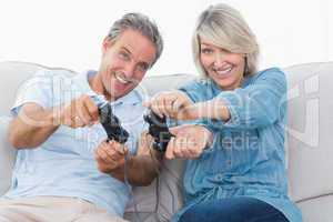 Couple playing video games on the sofa