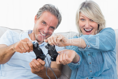 Couple playing video games on the couch