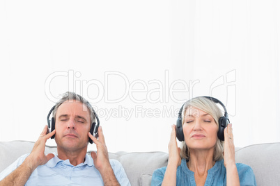 Couple relaxing and listening to music on the sofa