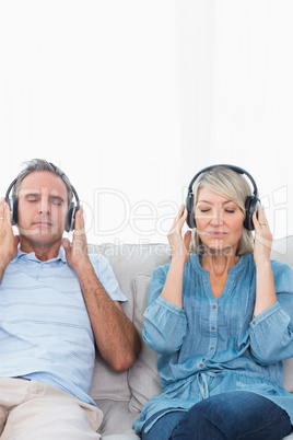 Couple relaxing and listening to music on the couch