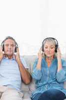 Couple relaxing and listening to music on the couch