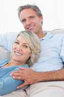 Smiling couple relaxing at home