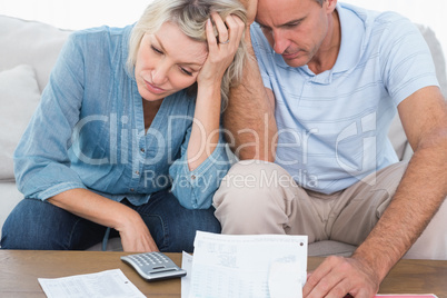 Worried couple going over bills