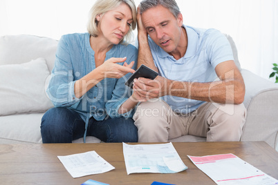 Worried couple going over their debt
