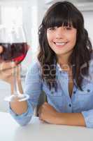 Attractive brunette having glass of red wine