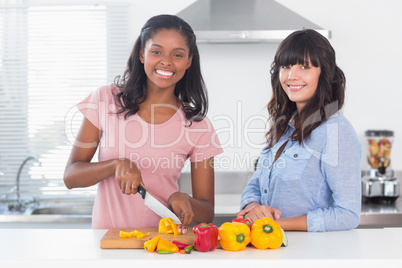 Cheerful friends preparing vegetables