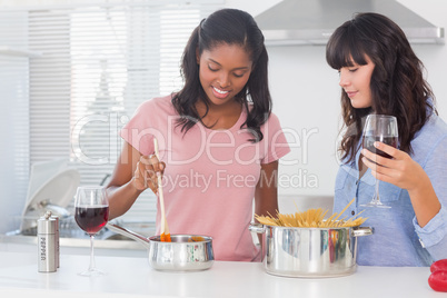 Happy friends making dinner together