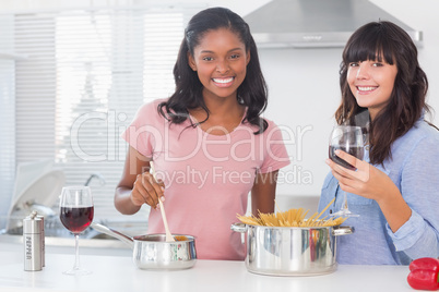 Happy friends preparing dinner together