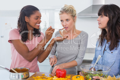 Cheerful friends preparing a meal together