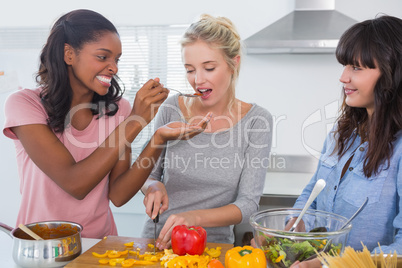 Happy friends preparing a meal together