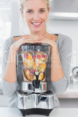 Blonde woman leaning on her juicer