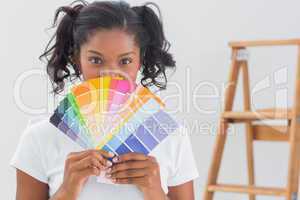 Happy woman showing colour charts