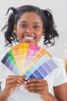 Smiling woman showing colour charts