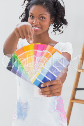 Excited woman pointing to colour charts