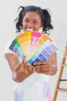 Excited woman showing colour charts and pointing
