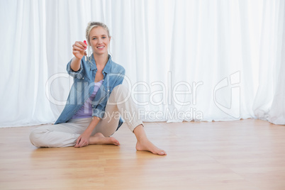 Blonde woman showing new house keys