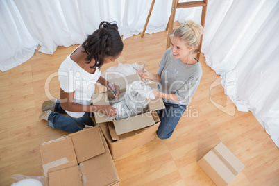 Young housemates unpacking in new home