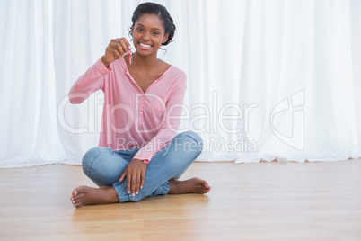 Happy young woman showing her new house keys