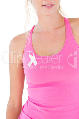 Woman wearing pink top and breast cancer ribbon